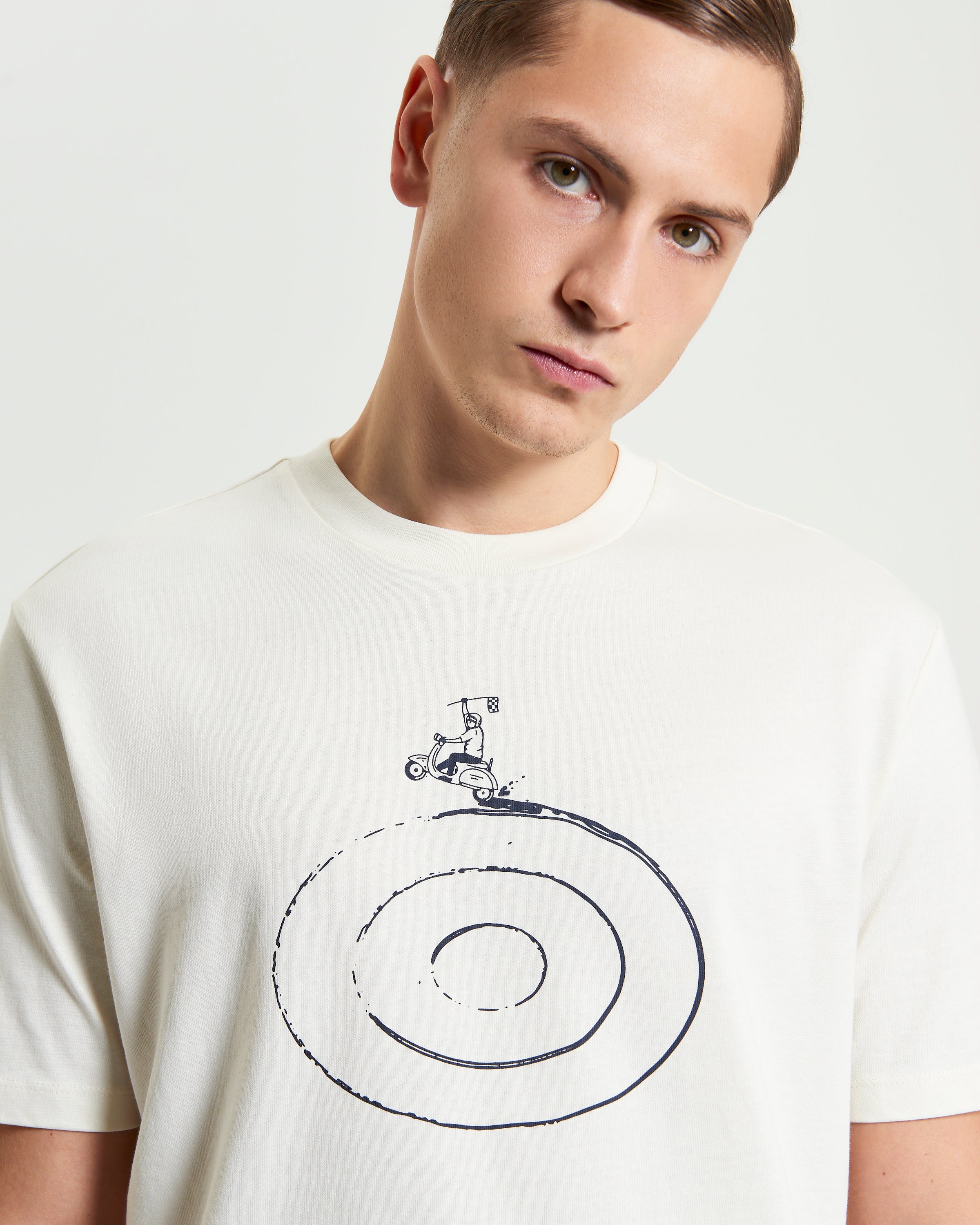 Model wearing the Rascal Rider Target Tee featuring a target and rider graphic in vintage style.