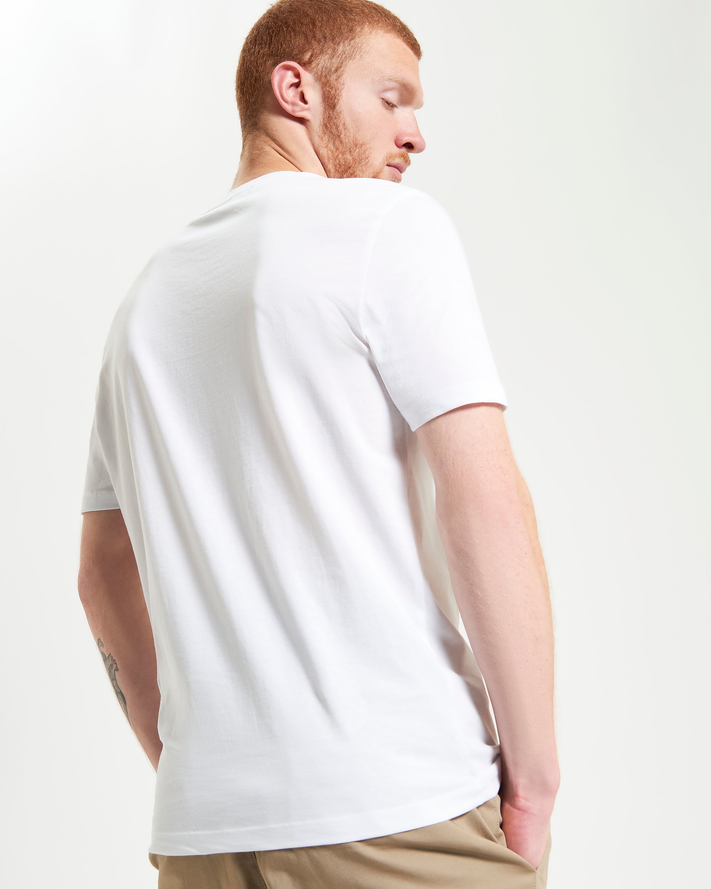 Guitar Poster Tee back view model showcasing artistic edge and casual style.