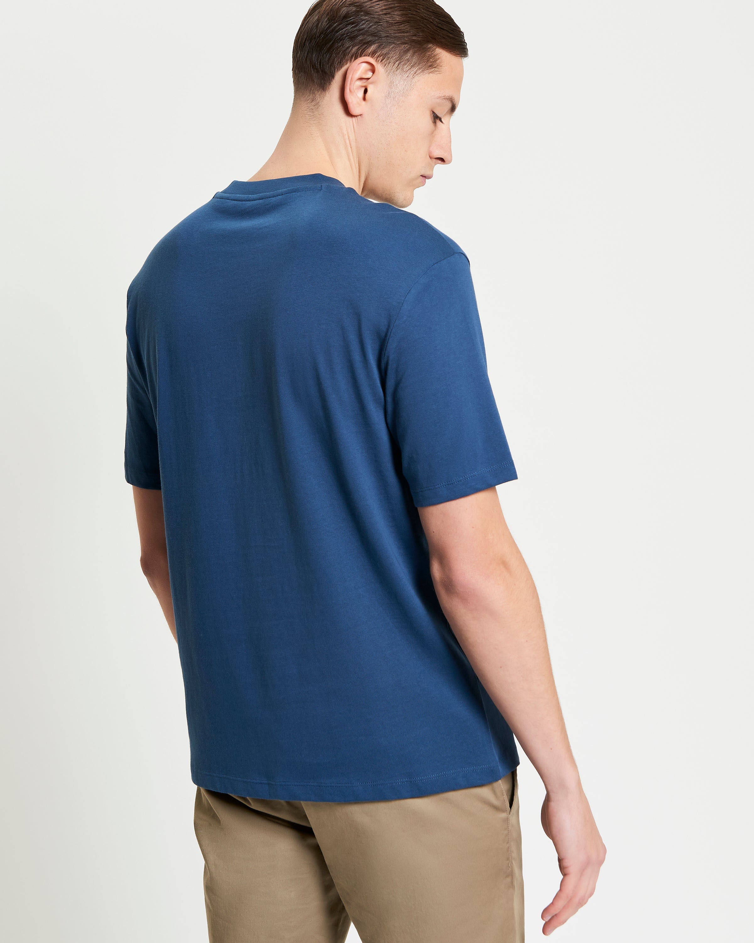 Back view of a man wearing a blue Mod Scooter Tee made from 100% organic cotton.