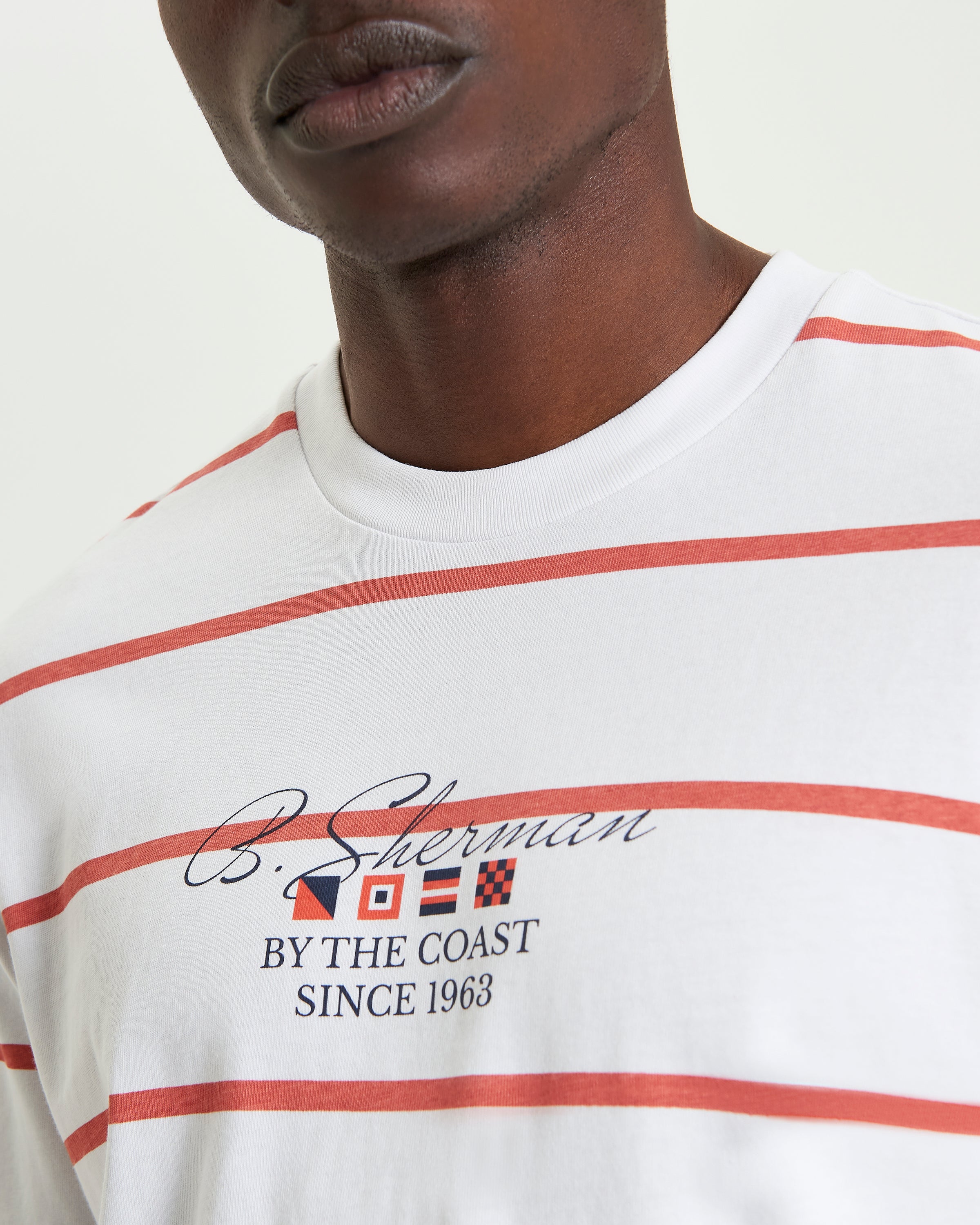 Stripe Script shirt featuring dynamic stripes and script accents on a model, showcasing bold design and refined style.