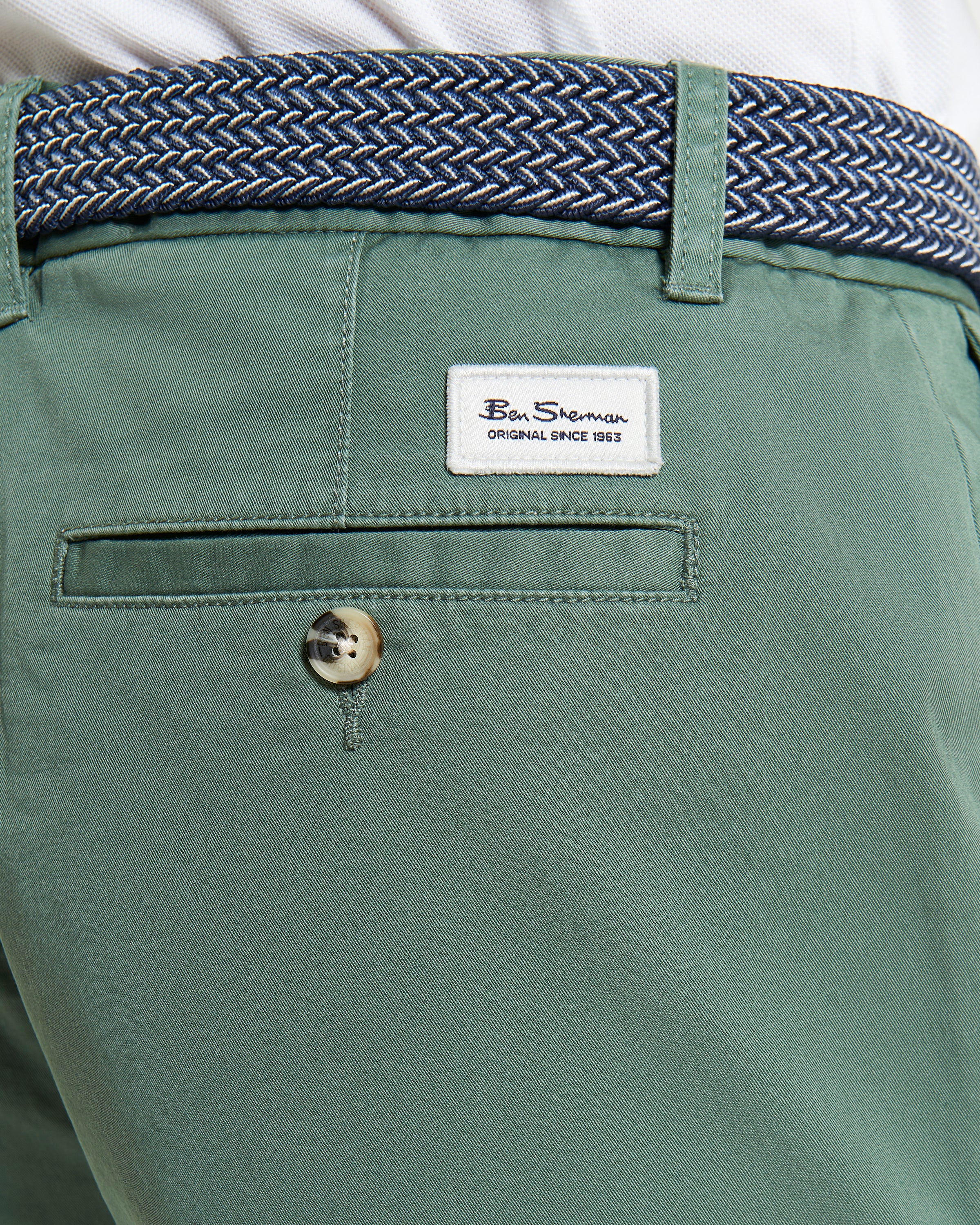 Signature Chino Short – green chino shorts showcasing branded buttons and woven belt detail.