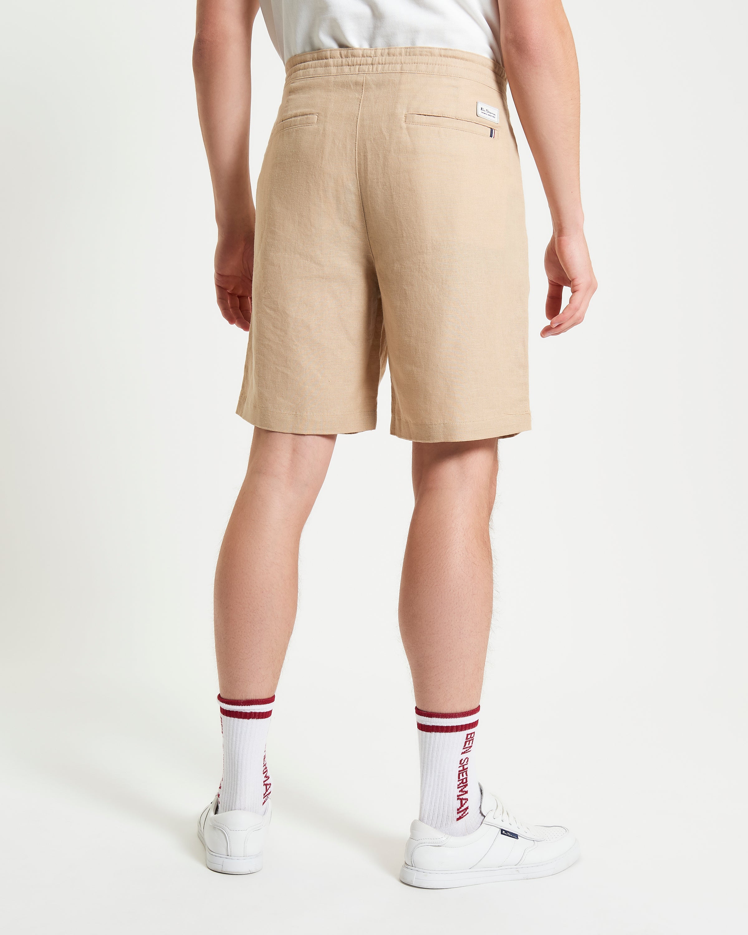 Linen Cotton Drawcord Short – back view of a model wearing beige shorts.