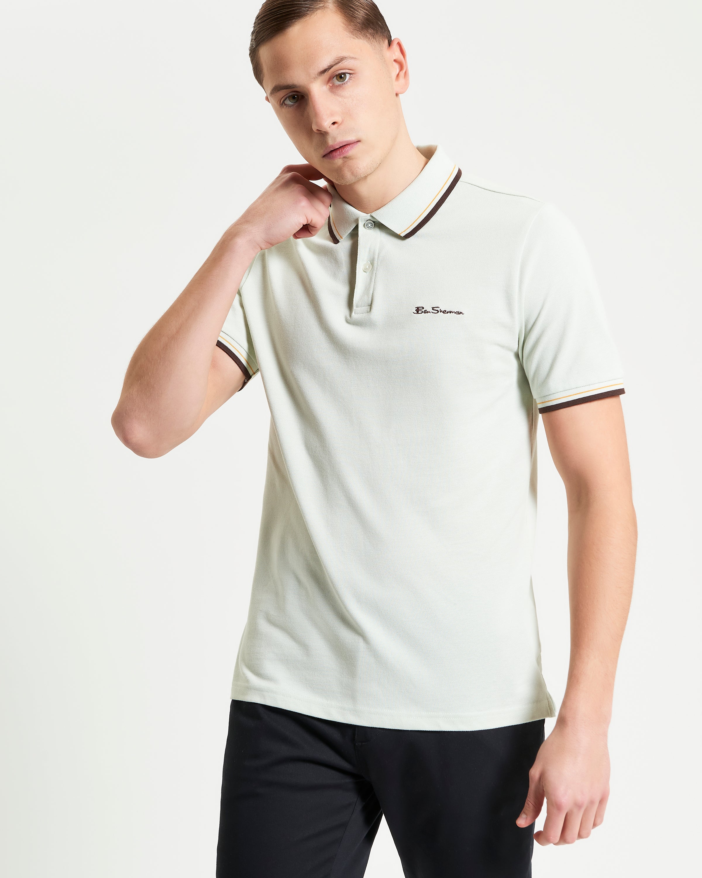Signature Pique Polo – light green with contrast detailing, showcasing a refined and sustainable casual wear look.