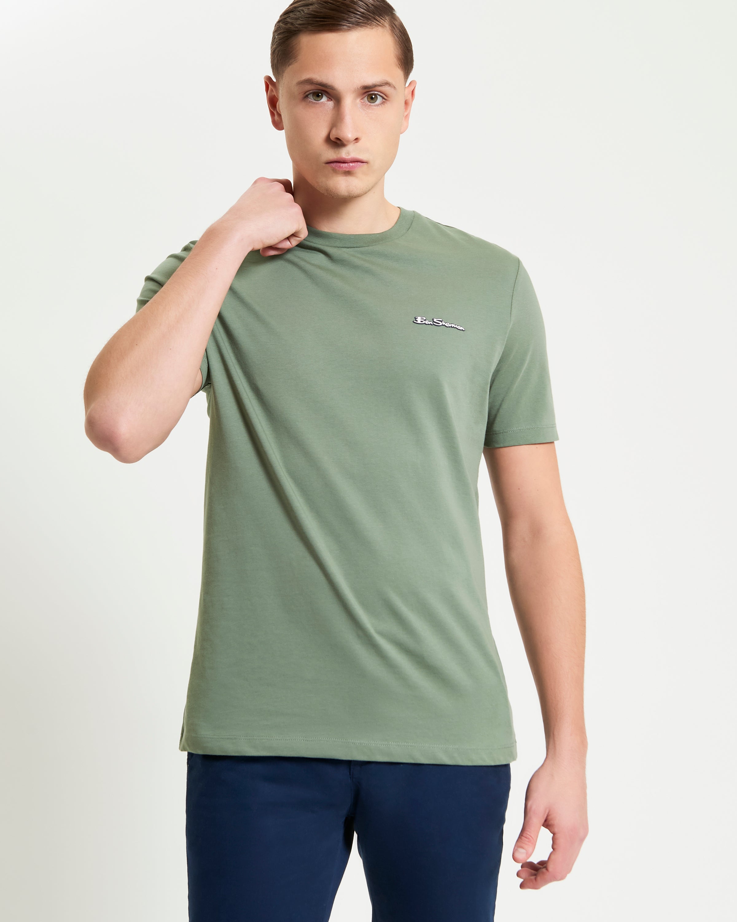 Signature Tee – Green Crew Neck with Branded Silicon Badge, Perfect for Casual Outings or Relaxing.