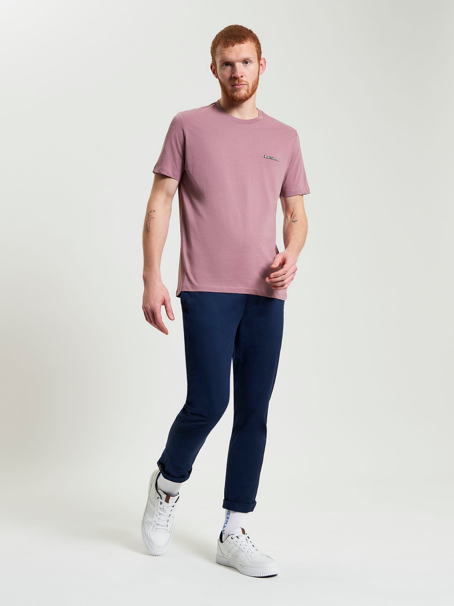Signature Tee – pink crew neck t-shirt styled with navy pants and white sneakers, perfect for casual outings.