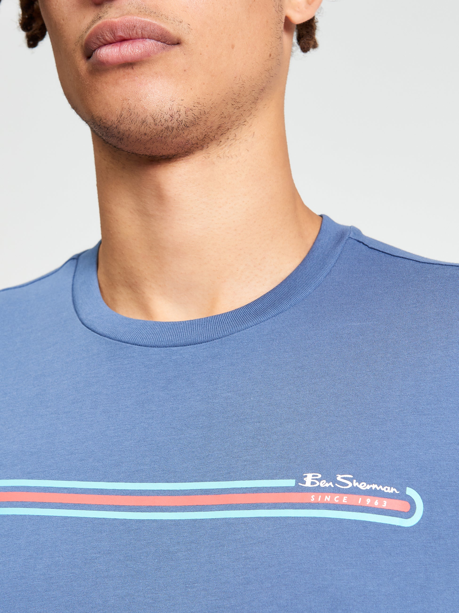 Core Stripe Tee by Ben Sherman featuring a printed stripe design on a blue organic cotton t-shirt.