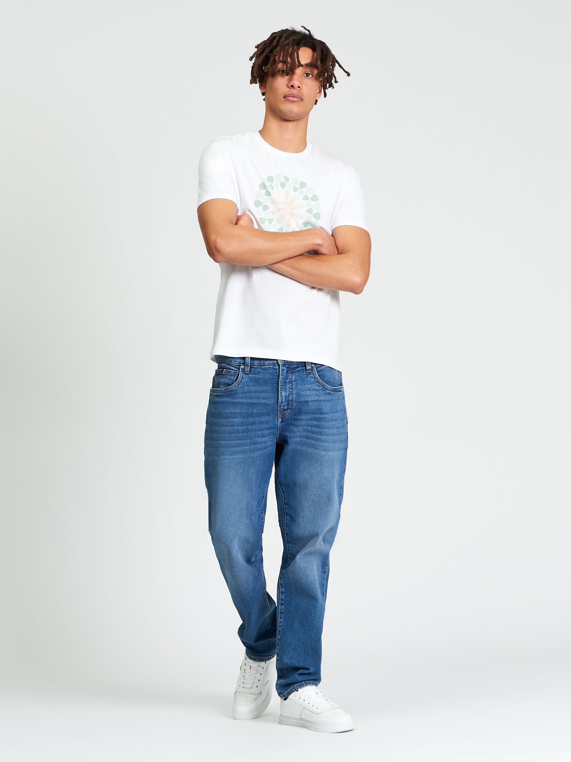 Model wearing Plectrum Target Tee with plectrum graphic design, paired with jeans and sneakers.