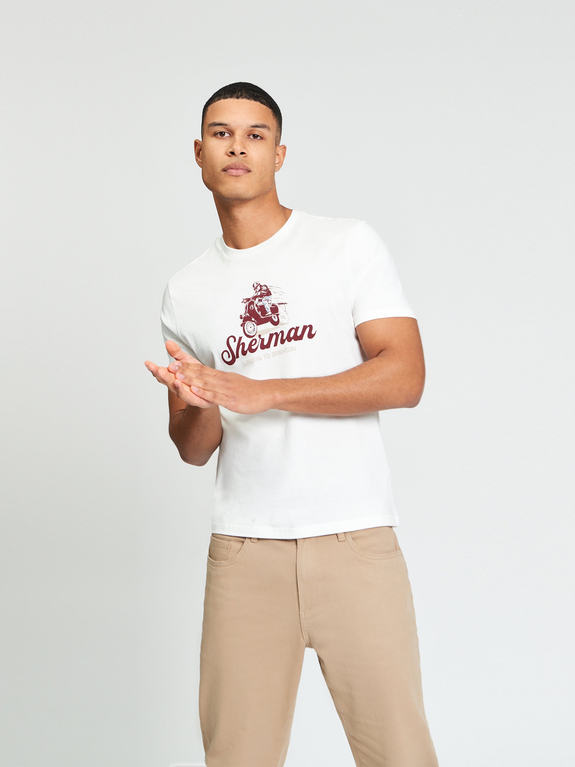 Race Day Tee – white shirt with bold graphic print, modeled by a man in casual style, showcasing comfort and design.