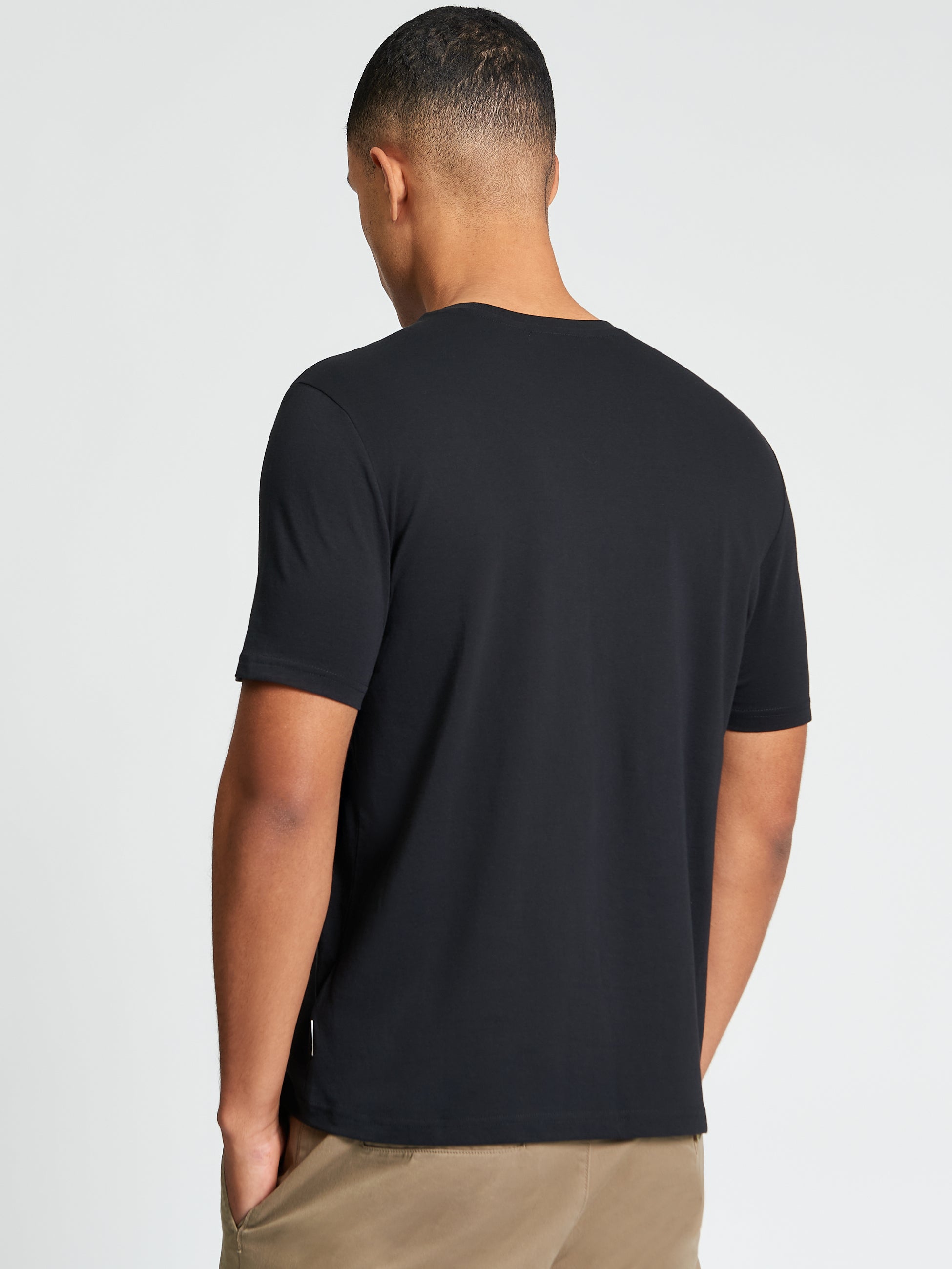 Back view of a man wearing the Speed Tee, crafted from 100% organic cotton, showcasing everyday comfort.