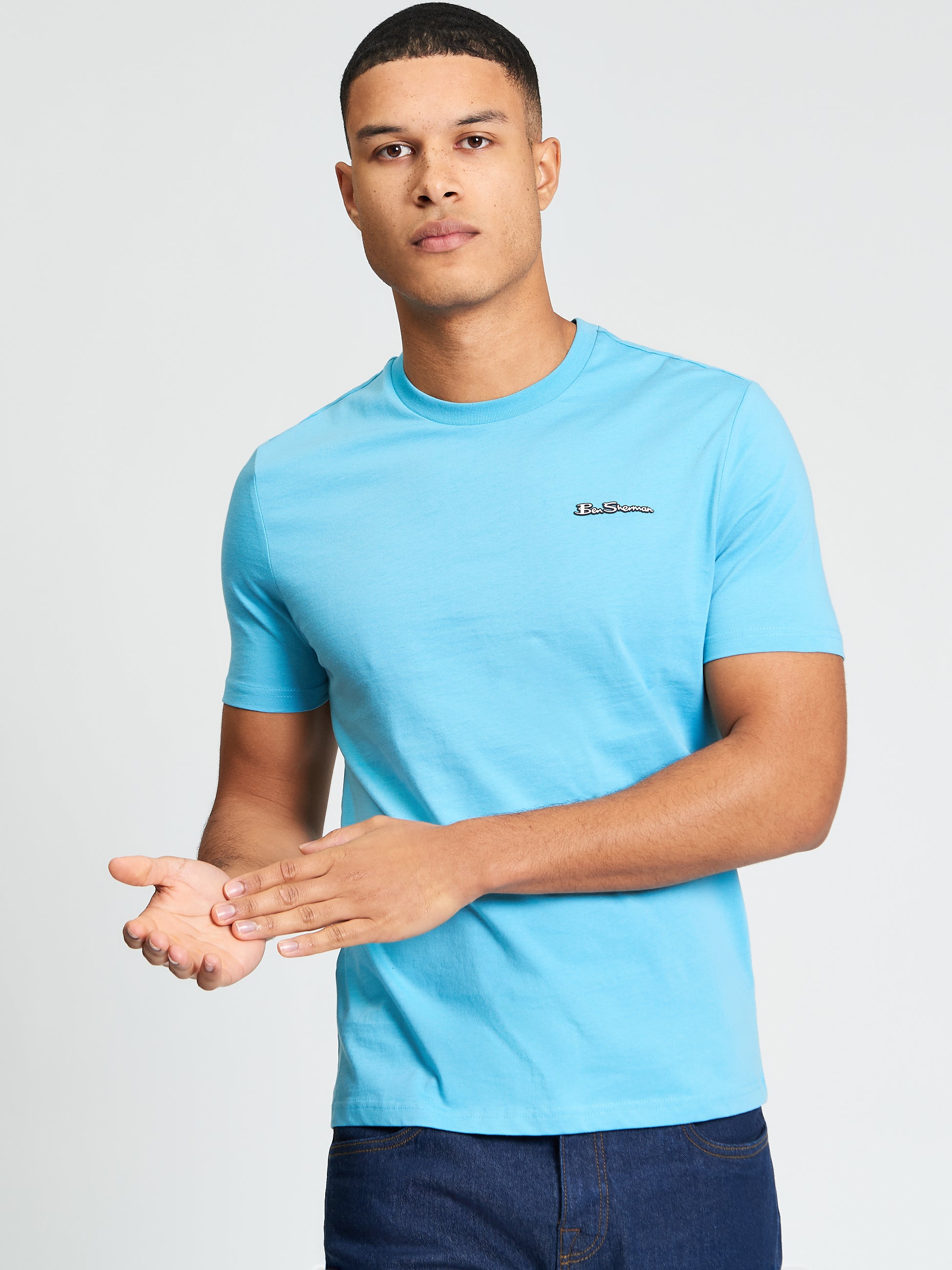 Signature Tee – Blue crew neck t-shirt with a branded silicon badge, comfortable and stylish.