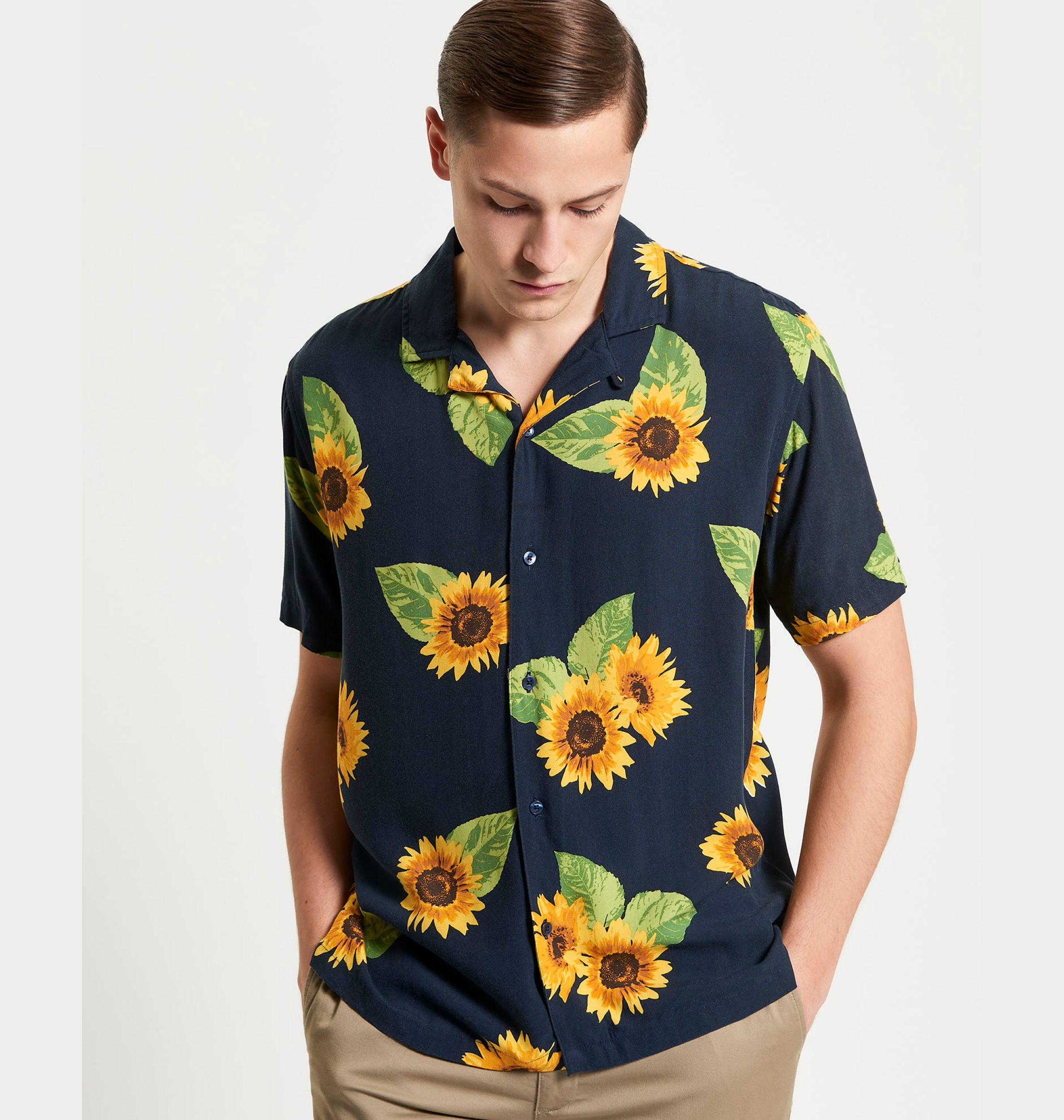 Man wearing Ben Sherman navy blue Sunflower shirt with sunflower pattern on a white background